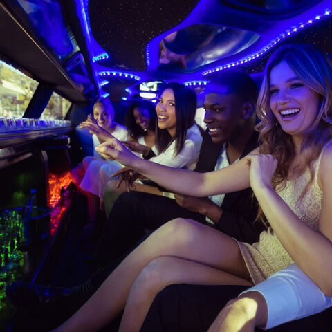 group of friends partying in a luxury limo