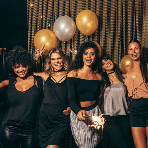 women smiling and celebrating at a party