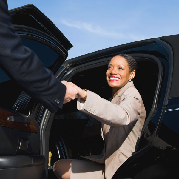 woman being helped out of a private car